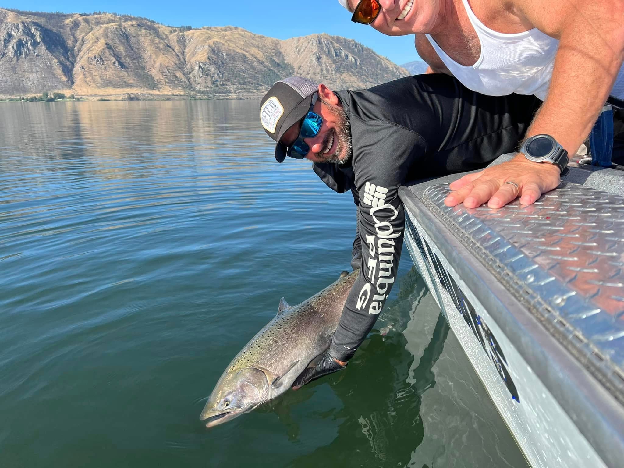 Guide releasing a salmon on the Columbia River